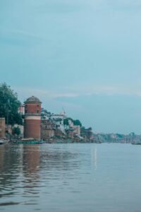 yatra_splash blog homepage with a serene Varanasi ghat background, palm trees, and spiritual travel options