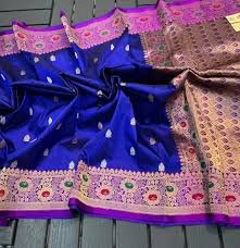 Elegant woman wearing a traditional red Banarasi saree with intricate gold zari work